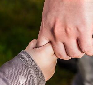 child holding parents finger